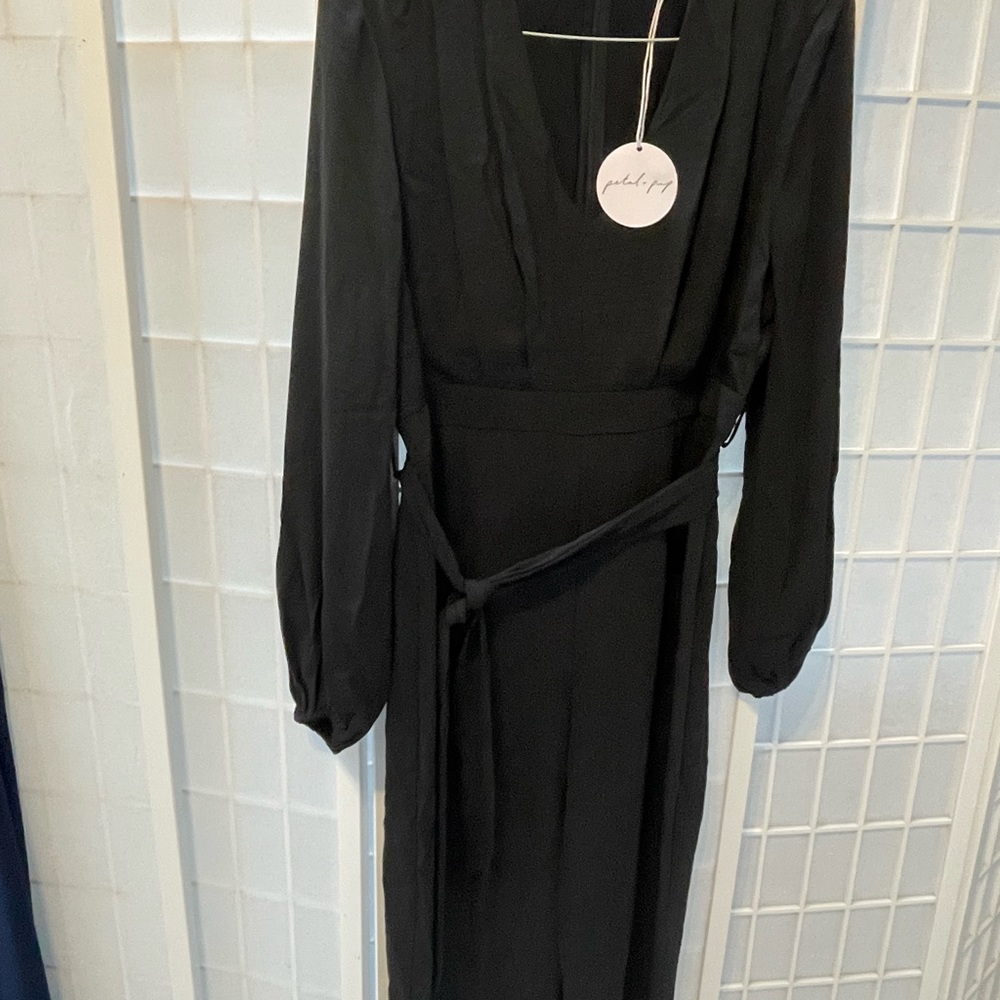 Brand new black jumpsuit. Long sleeve. Fit is like a U.S. size 10.